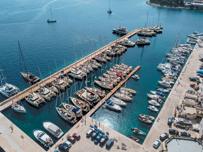 Stunning aerial view of a Croatian marina filled with yachts and sailboats moored along the docks.